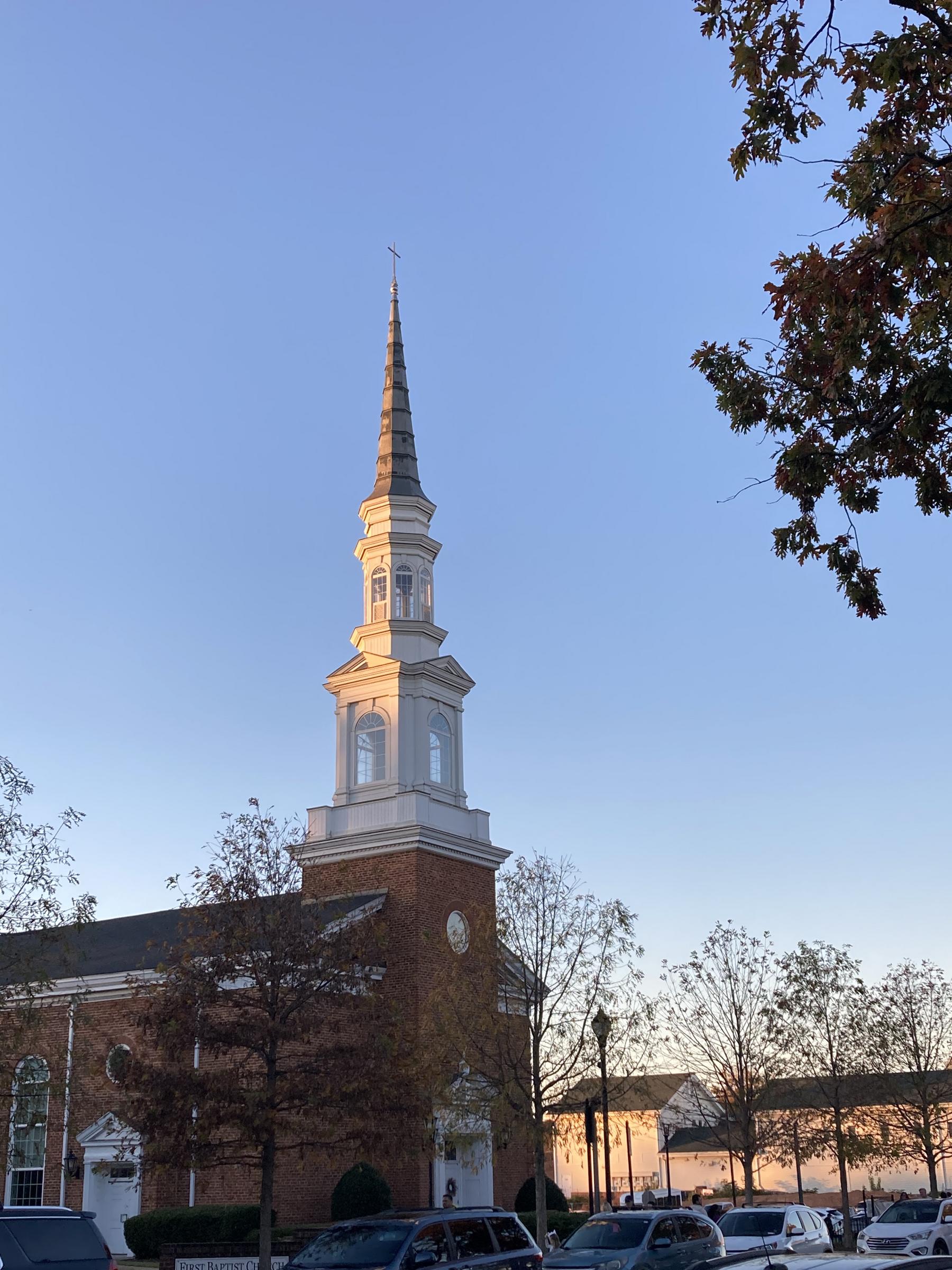 White church steeple against a blue sky